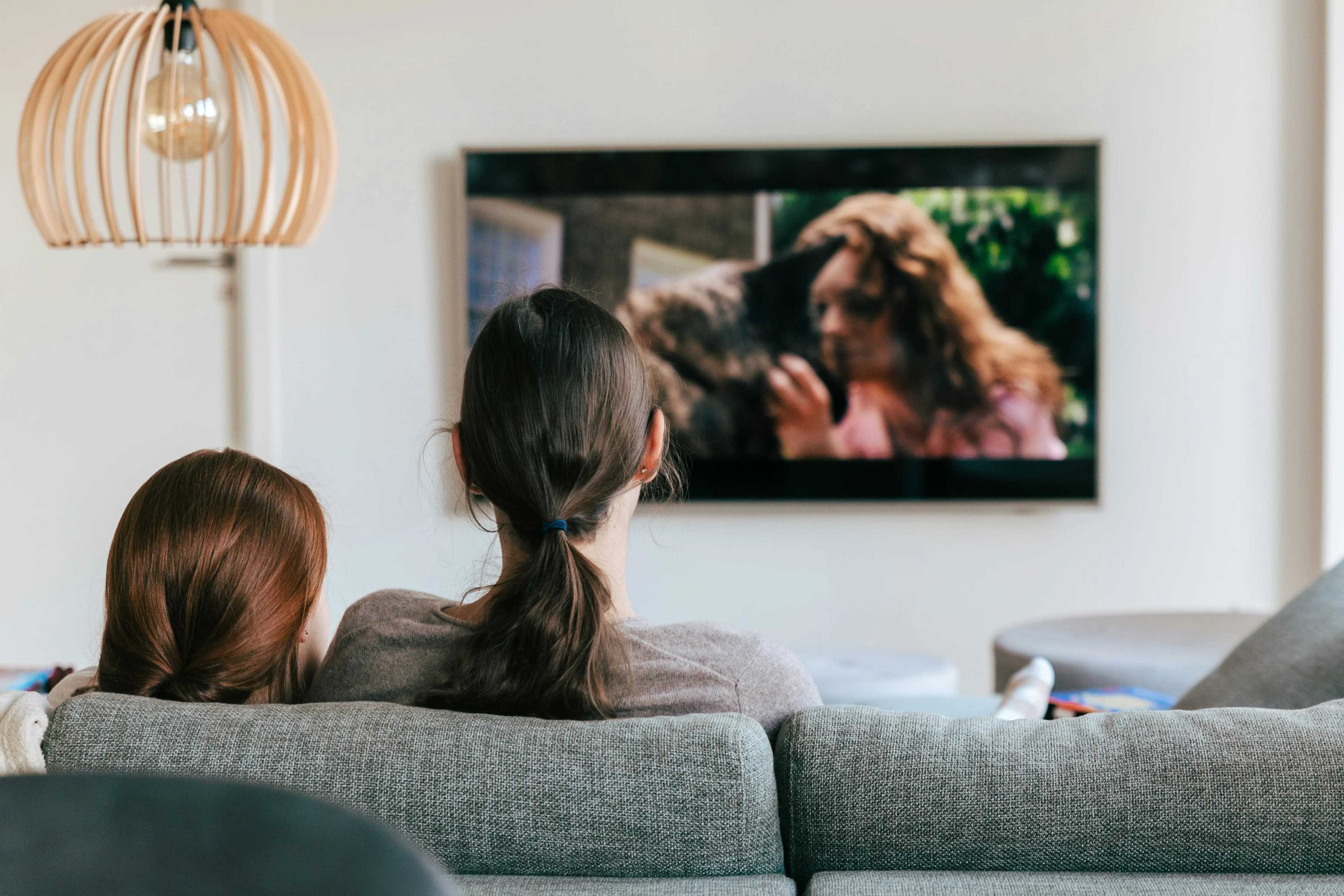Family relaxing together while watching television at home